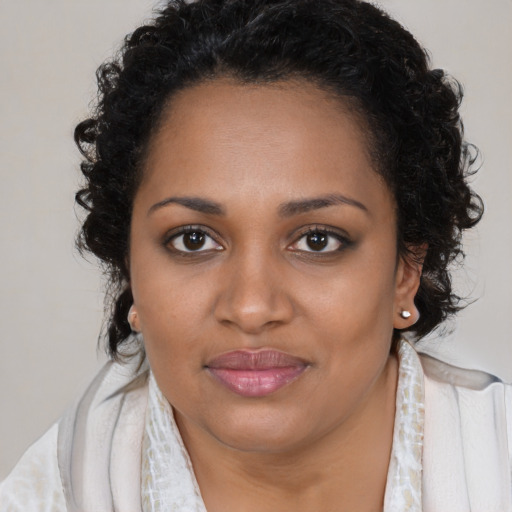 Joyful black young-adult female with medium  brown hair and brown eyes