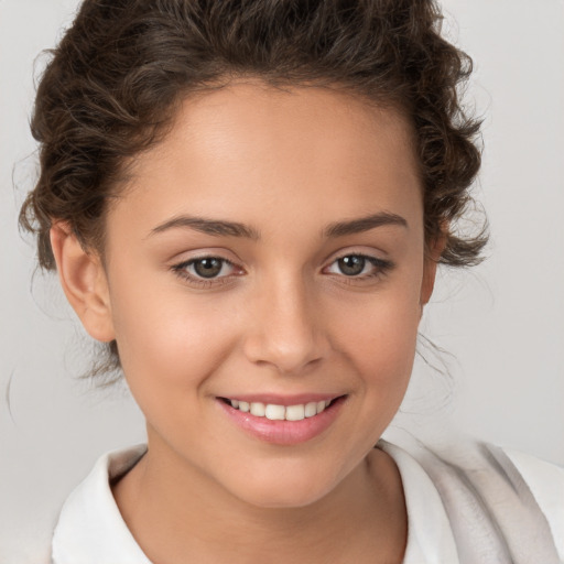 Joyful white child female with medium  brown hair and brown eyes