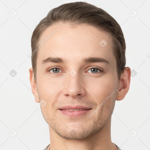 Joyful white young-adult male with short  brown hair and grey eyes