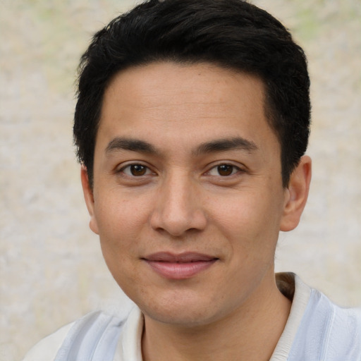 Joyful white young-adult male with short  black hair and brown eyes