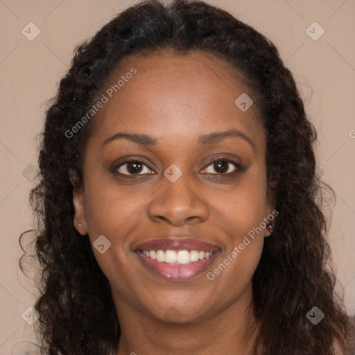 Joyful black young-adult female with long  brown hair and brown eyes