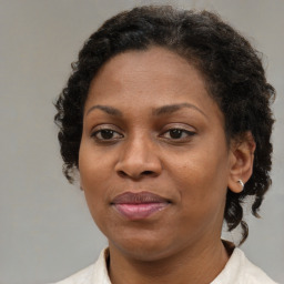 Joyful black adult female with short  brown hair and brown eyes