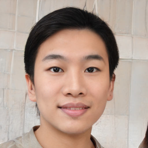 Joyful asian young-adult male with short  black hair and brown eyes