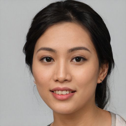 Joyful asian young-adult female with medium  black hair and brown eyes