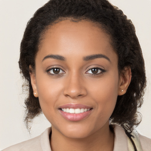 Joyful latino young-adult female with long  brown hair and brown eyes