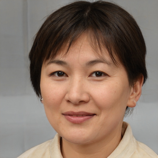 Joyful white adult female with medium  brown hair and brown eyes