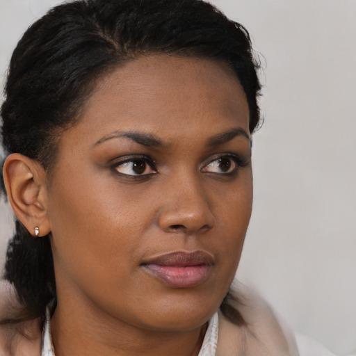 Joyful black young-adult female with medium  brown hair and brown eyes