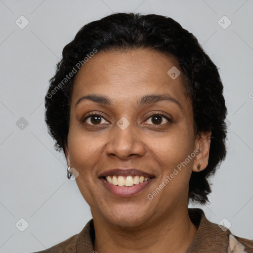 Joyful latino adult female with short  brown hair and brown eyes