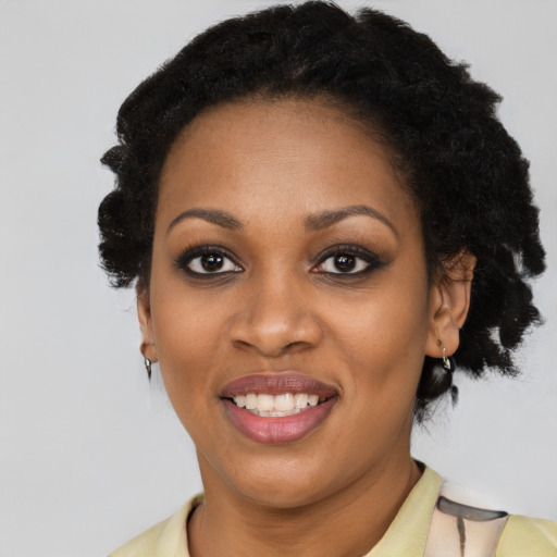 Joyful black young-adult female with medium  brown hair and brown eyes