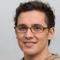 Joyful white adult male with short  brown hair and grey eyes