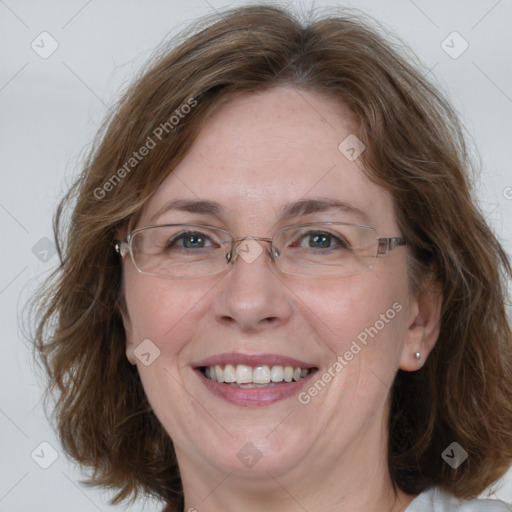 Joyful white adult female with medium  brown hair and blue eyes