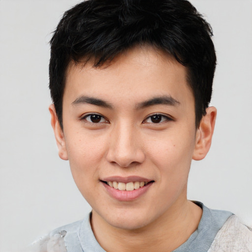 Joyful asian young-adult male with short  brown hair and brown eyes
