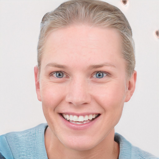 Joyful white young-adult female with short  brown hair and blue eyes