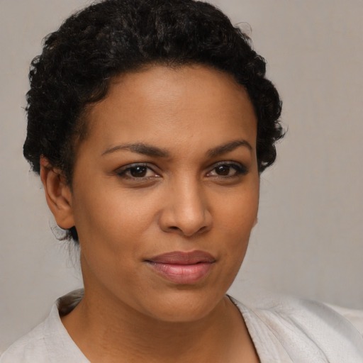 Joyful latino young-adult female with short  brown hair and brown eyes