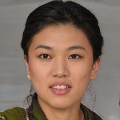 Joyful asian young-adult female with short  brown hair and brown eyes