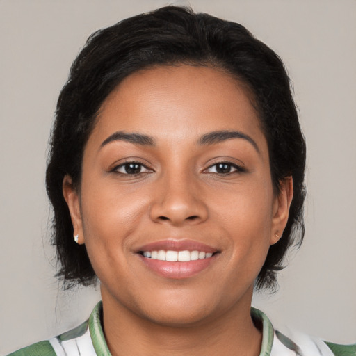 Joyful latino young-adult female with medium  brown hair and brown eyes