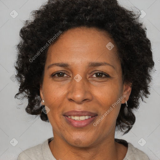 Joyful black adult female with short  brown hair and brown eyes