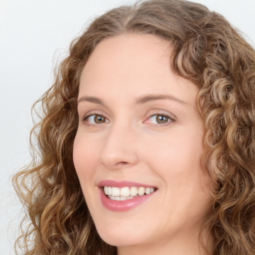 Joyful white young-adult female with long  brown hair and green eyes