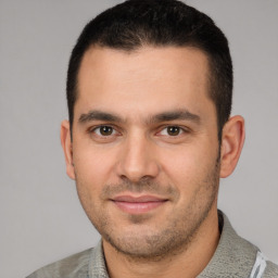 Joyful white young-adult male with short  black hair and brown eyes