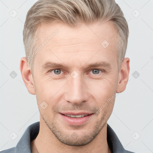 Joyful white adult male with short  brown hair and grey eyes