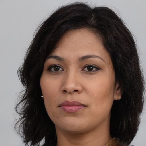 Joyful asian young-adult female with medium  brown hair and brown eyes