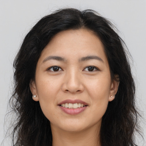 Joyful white young-adult female with long  brown hair and brown eyes