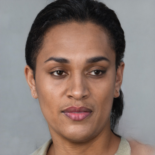 Joyful latino young-adult female with short  brown hair and brown eyes