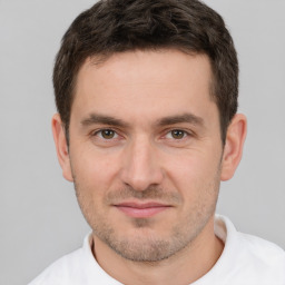 Joyful white young-adult male with short  brown hair and brown eyes