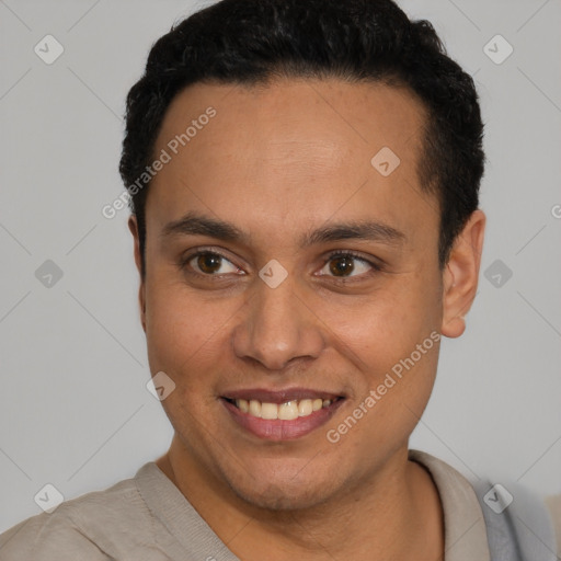 Joyful latino young-adult male with short  black hair and brown eyes