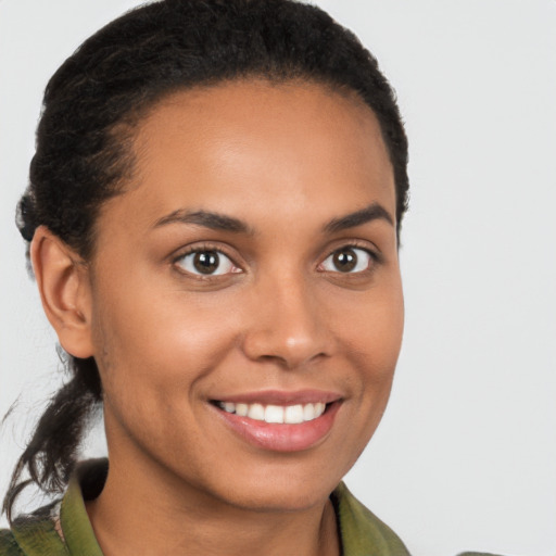 Joyful latino young-adult female with short  brown hair and brown eyes