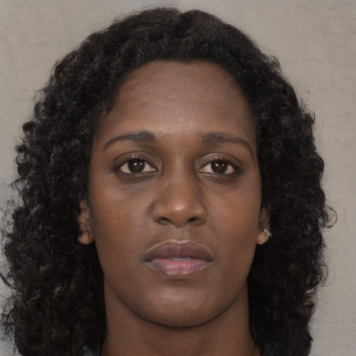 Neutral black young-adult female with long  brown hair and brown eyes