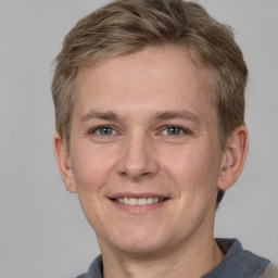 Joyful white adult male with short  brown hair and grey eyes