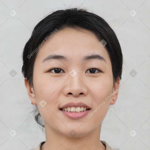 Joyful asian young-adult female with short  black hair and brown eyes