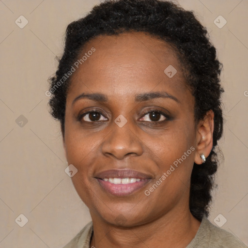 Joyful black young-adult female with medium  brown hair and brown eyes