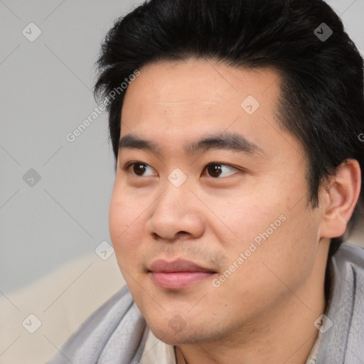 Joyful asian young-adult male with short  black hair and brown eyes