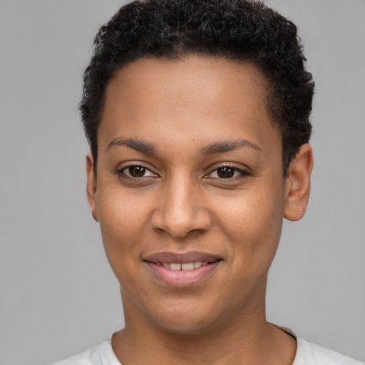 Joyful black young-adult female with short  brown hair and brown eyes