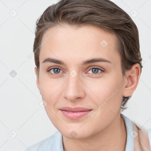 Joyful white young-adult female with short  brown hair and grey eyes