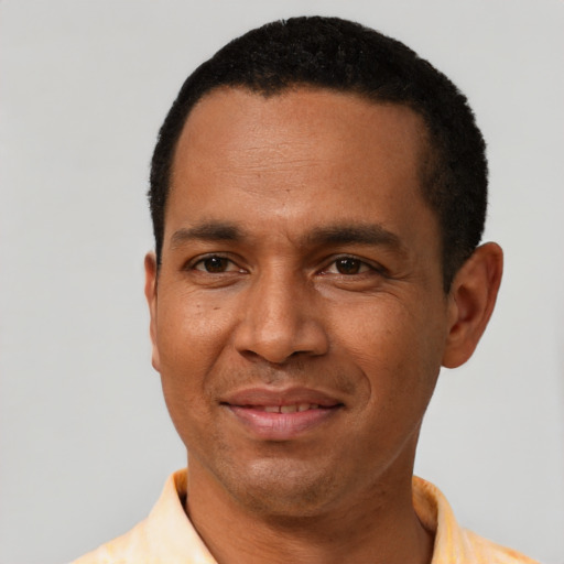 Joyful latino adult male with short  black hair and brown eyes
