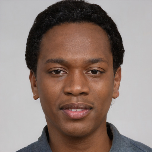 Joyful black young-adult male with short  black hair and brown eyes