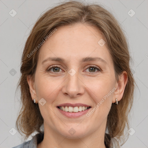 Joyful white adult female with medium  brown hair and grey eyes