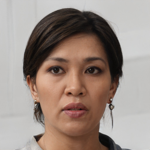 Neutral asian young-adult female with medium  brown hair and brown eyes