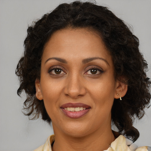 Joyful black young-adult female with medium  brown hair and brown eyes