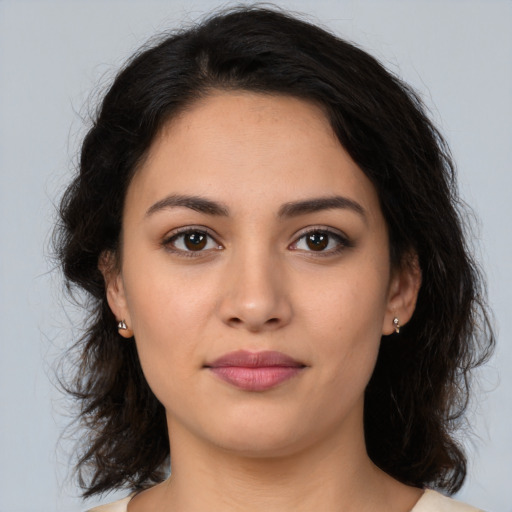 Joyful latino young-adult female with medium  brown hair and brown eyes