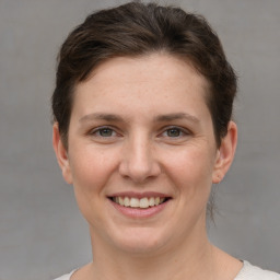 Joyful white young-adult female with short  brown hair and grey eyes