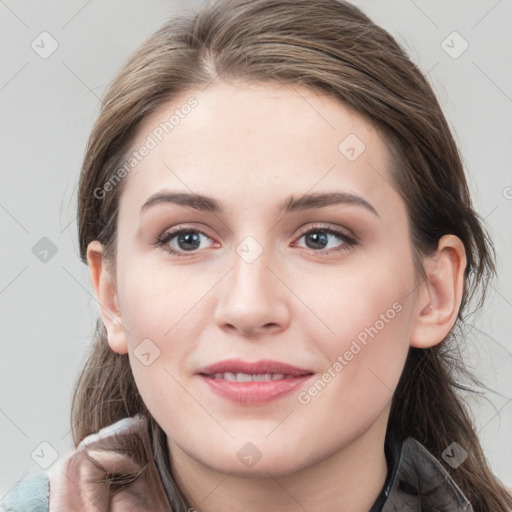 Joyful white young-adult female with long  brown hair and grey eyes