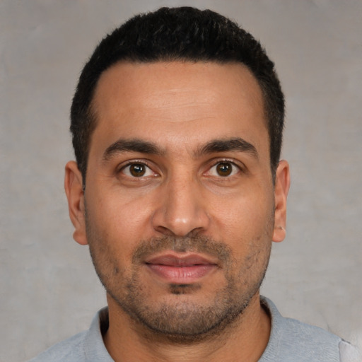 Joyful white young-adult male with short  black hair and brown eyes