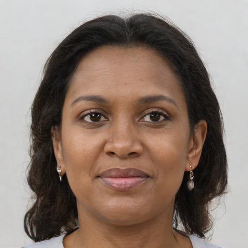 Joyful black adult female with medium  brown hair and brown eyes