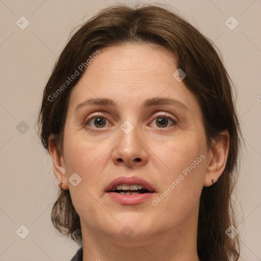 Joyful white adult female with medium  brown hair and brown eyes