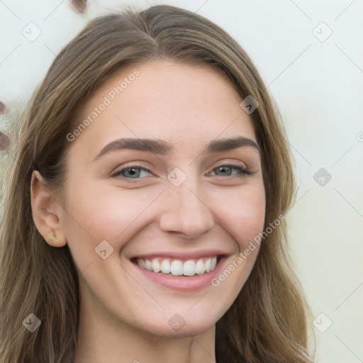 Joyful white young-adult female with long  brown hair and green eyes