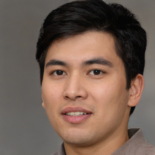 Joyful asian young-adult male with short  black hair and brown eyes
